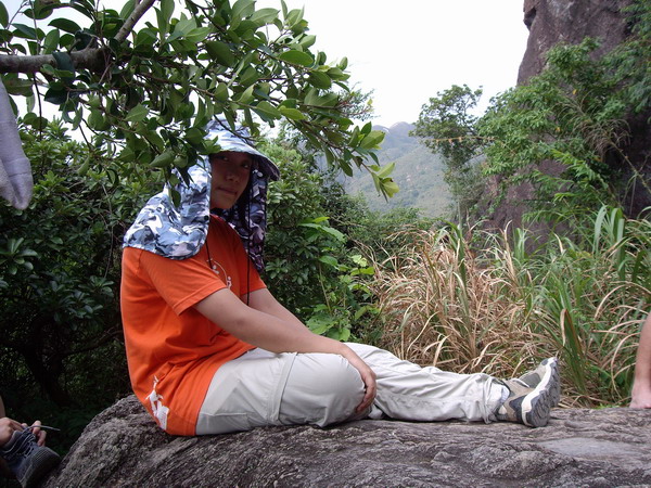 Alice sitting on rock